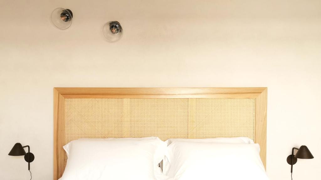two lights above a bed with white pillows at Santa Lucia Maccarese - Residenza Agricola in Maccarese