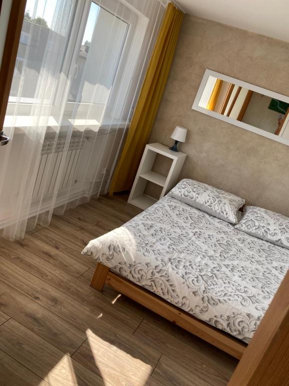 Postel nebo postele na pokoji v ubytování Apartamenty W Domu