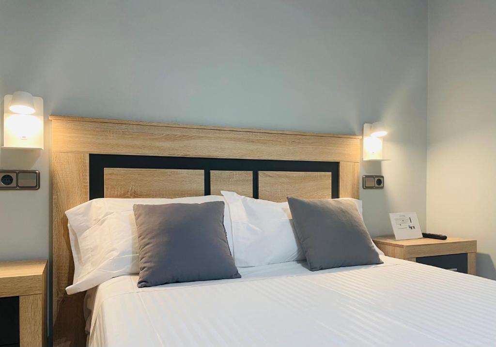 Postel nebo postele na pokoji v ubytování Hostal Los Ángeles