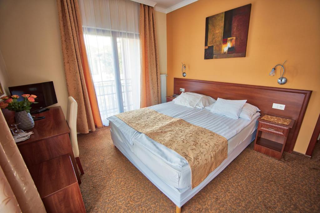 Postel nebo postele na pokoji v ubytování Hotel Viktória