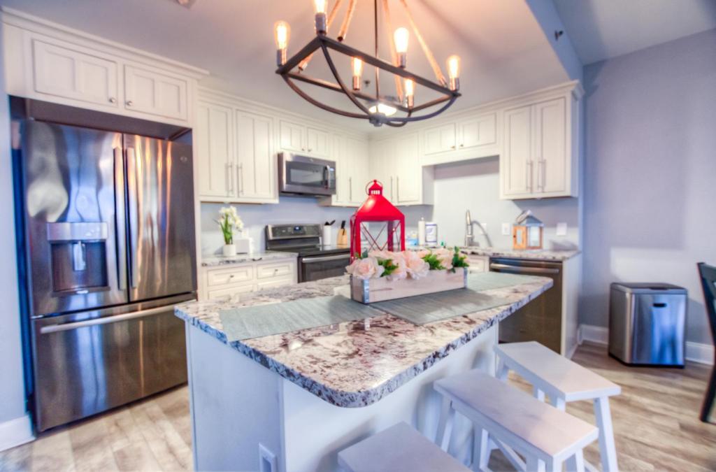 a kitchen with a large island with a red item on it at BRAND NEW! Laketown Wharf 633! Amazing 3 BD, Great Location, And Awesome Amenities! in Panama City Beach