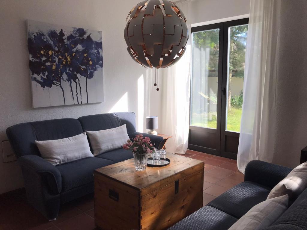 a living room with a blue couch and a table at Ferienhaus Chalet Dr. Winkler in Speichersdorf