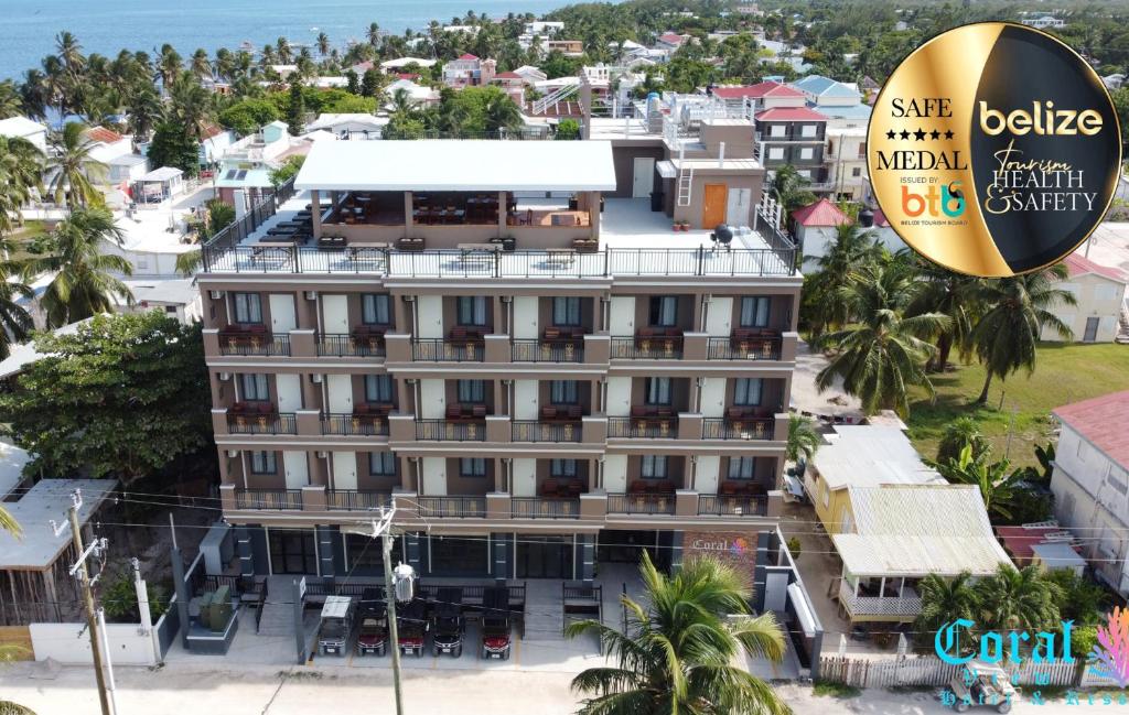 
a large building with a sign on the side of it at Coral View Hotel & Resort in Caye Caulker

