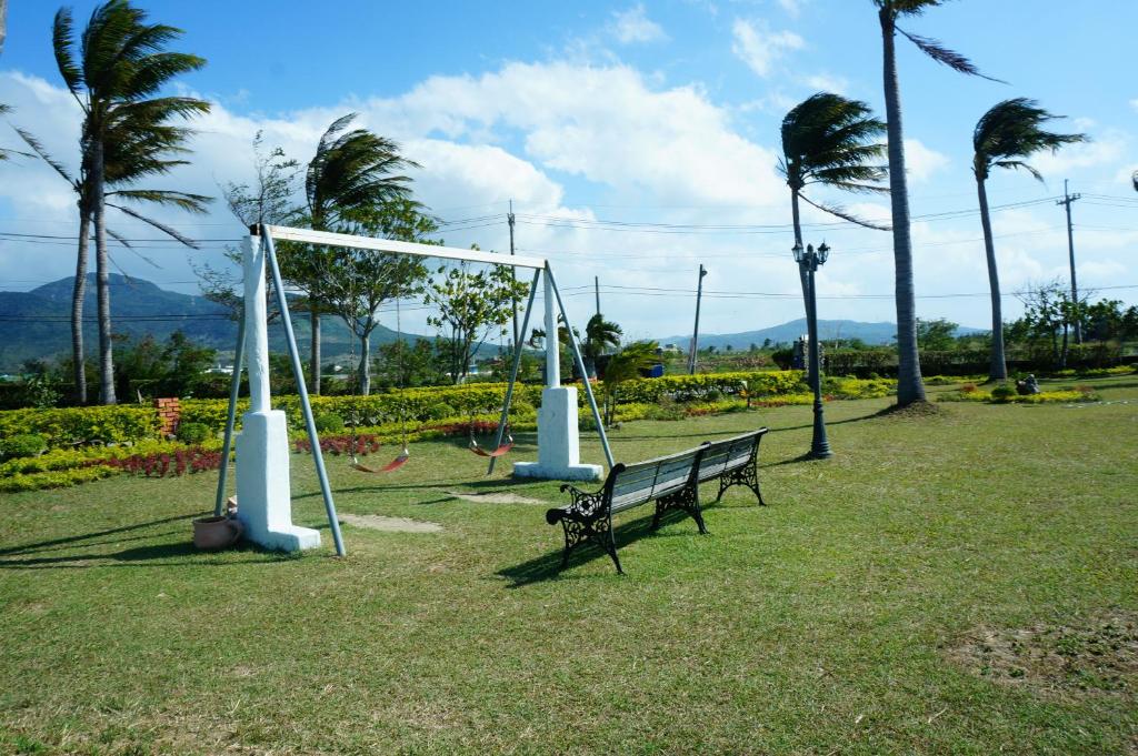 a park with a bench and a swing set at Sine Ya Hostel in Hengchun South Gate