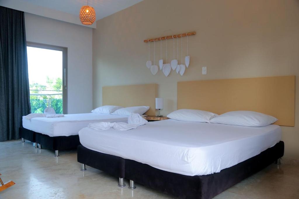 Voodi või voodid majutusasutuse Awa De Mar Hotel Tolu toas