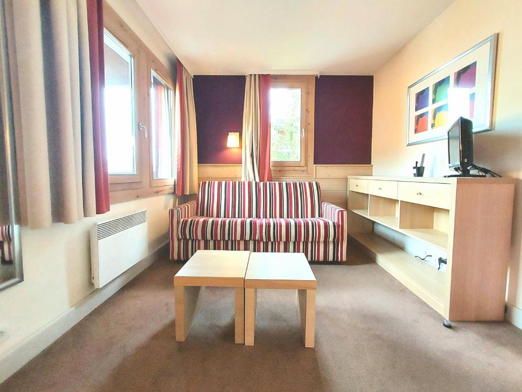 a living room with a couch and a coffee table at Appartement La Plagne-Tarentaise, 1 pièce, 4 personnes - FR-1-351-146 in La Plagne Tarentaise