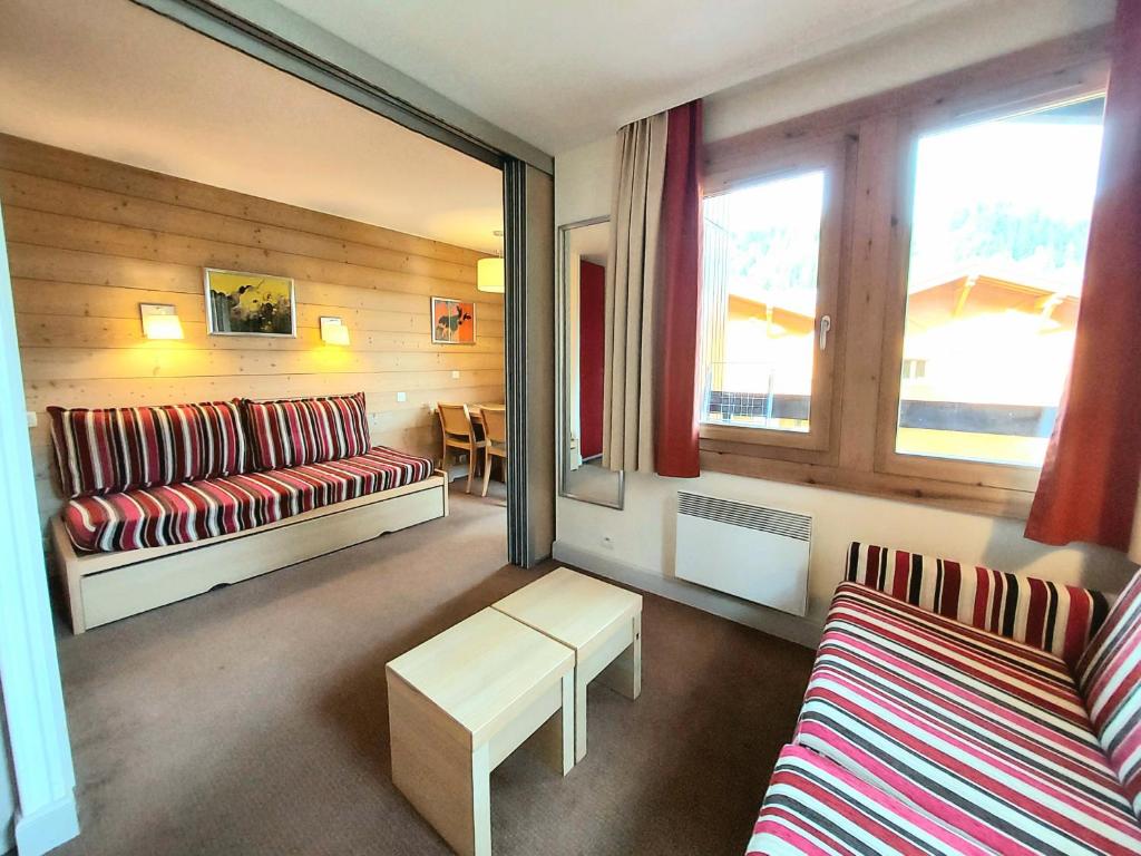 a living room with a couch and a table at Appartement La Plagne-Tarentaise, 1 pièce, 4 personnes - FR-1-351-146 in La Plagne Tarentaise