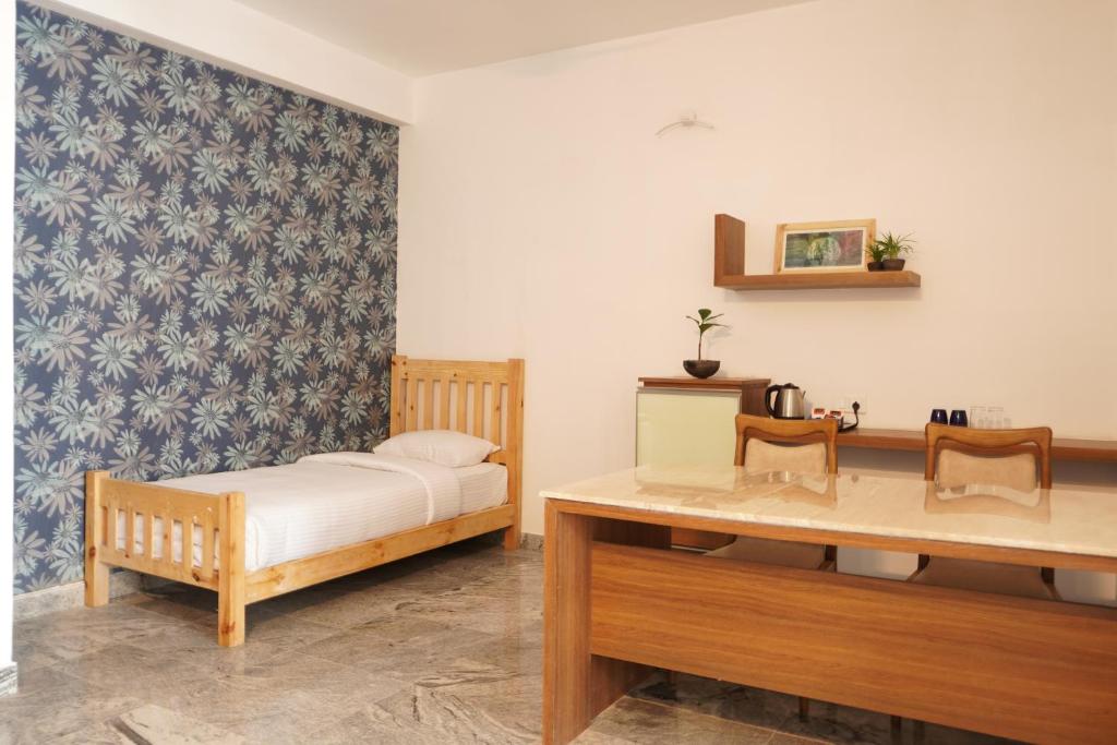 Postel nebo postele na pokoji v ubytování MERIDIAN HILL TOP YERCAUD