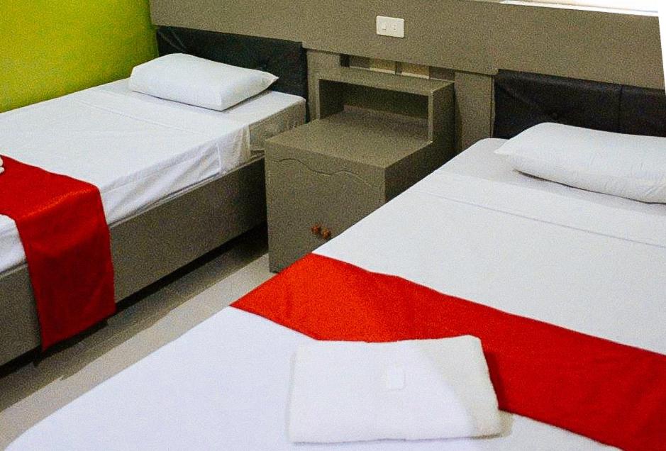 Postel nebo postele na pokoji v ubytování RedDoorz at EM Pensiontel Butuan City