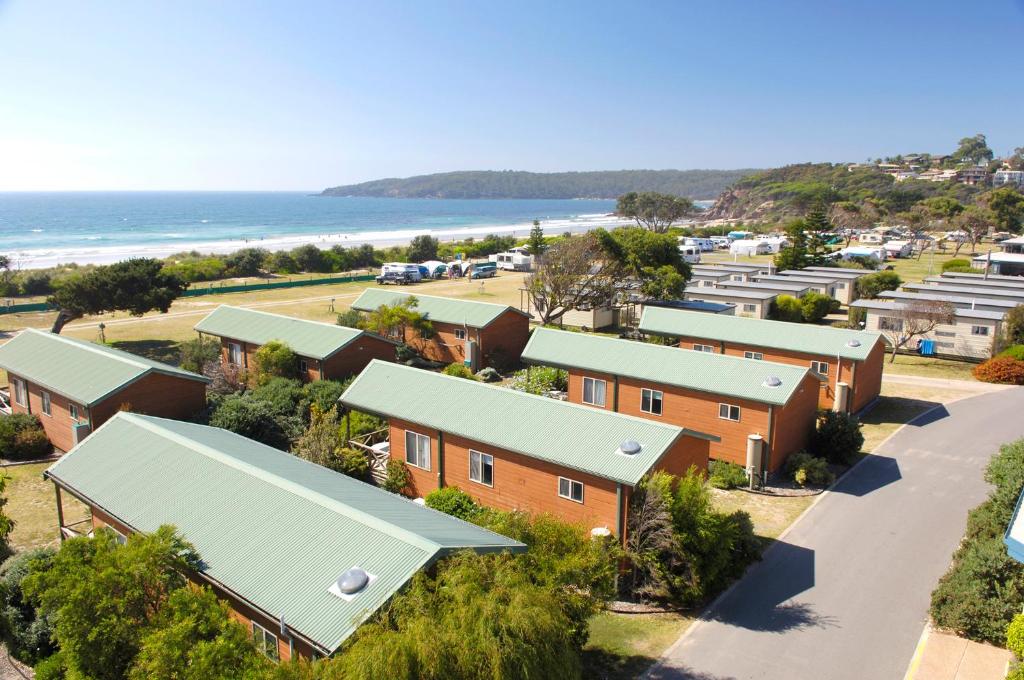 an aerial view of houses at the beach at Discovery Parks - Pambula Beach in Pambula