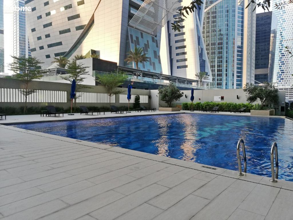 a swimming pool in a city with tall buildings at bnbmehomes - Apt In Business Bay - Heart of Dubai - 1820 in Dubai