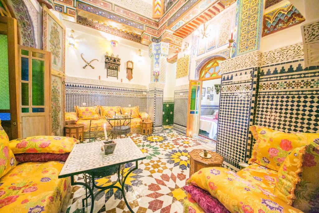 a living room with a couch and a table at Palais Fes Yahya in Fès al Bali