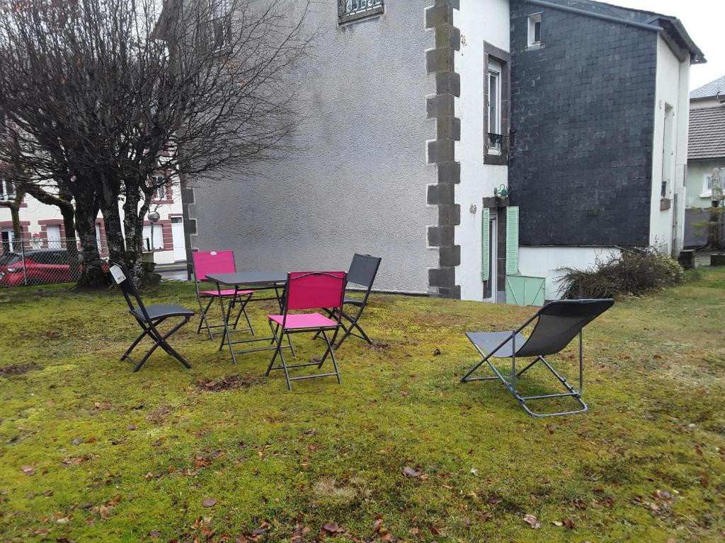 a group of chairs and a table in a yard at quereuilh in Le Mont-Dore