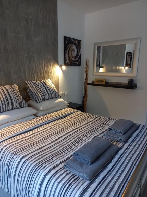 a bedroom with a bed with towels on it at Caleta Holiday Bungalow in Caleta De Fuste