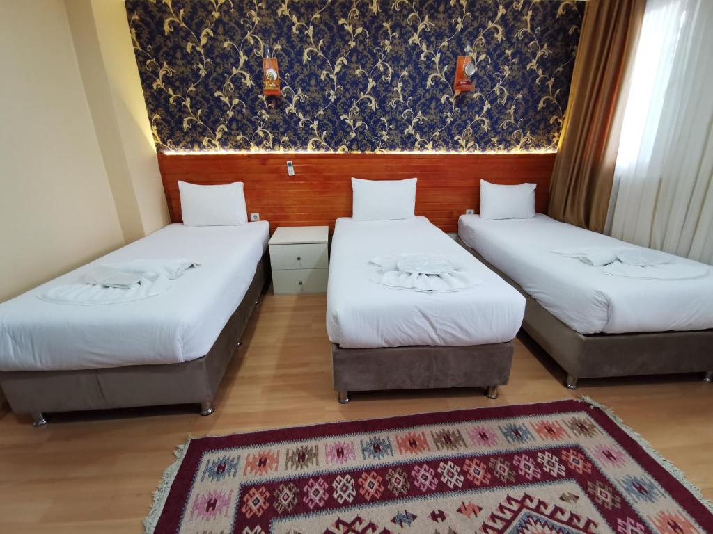 Postel nebo postele na pokoji v ubytování Otantik Hotel