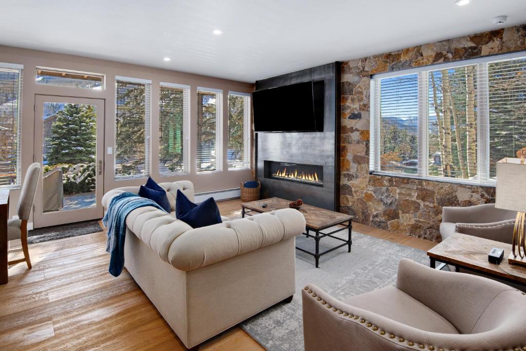 a living room with a couch and a fireplace at Sun Vail 14A condo in Vail