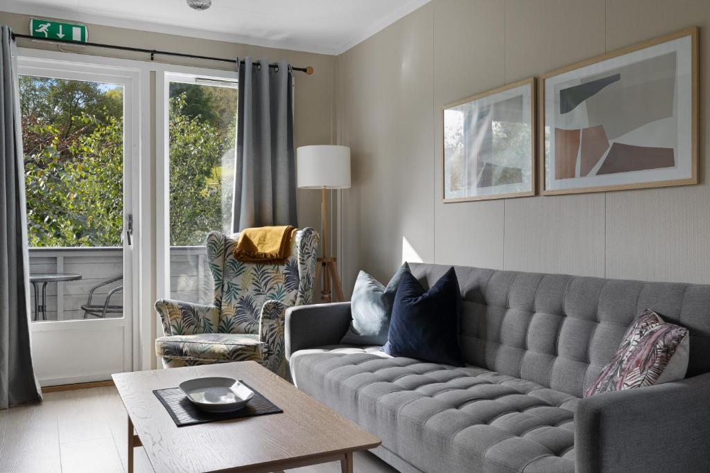 a living room with a couch and a table at Master Apartment Hotels in Bergen