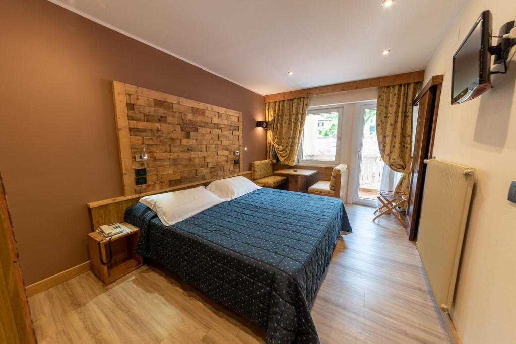 Postel nebo postele na pokoji v ubytování Hotel Pangrazzi - 3 stelle superior