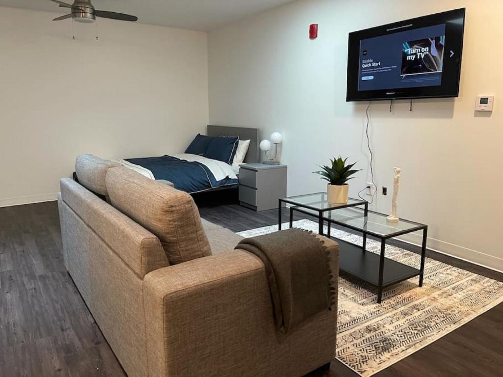 a living room with a couch and a bed at Apt 255 Cozy and Sleek Dwelling Min from Ft Leavenworth in Leavenworth