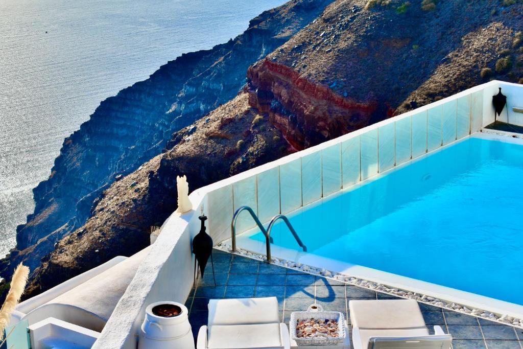 a swimming pool with a view of the ocean at Aeolos Art & Eco Suites Adults Only in Imerovigli