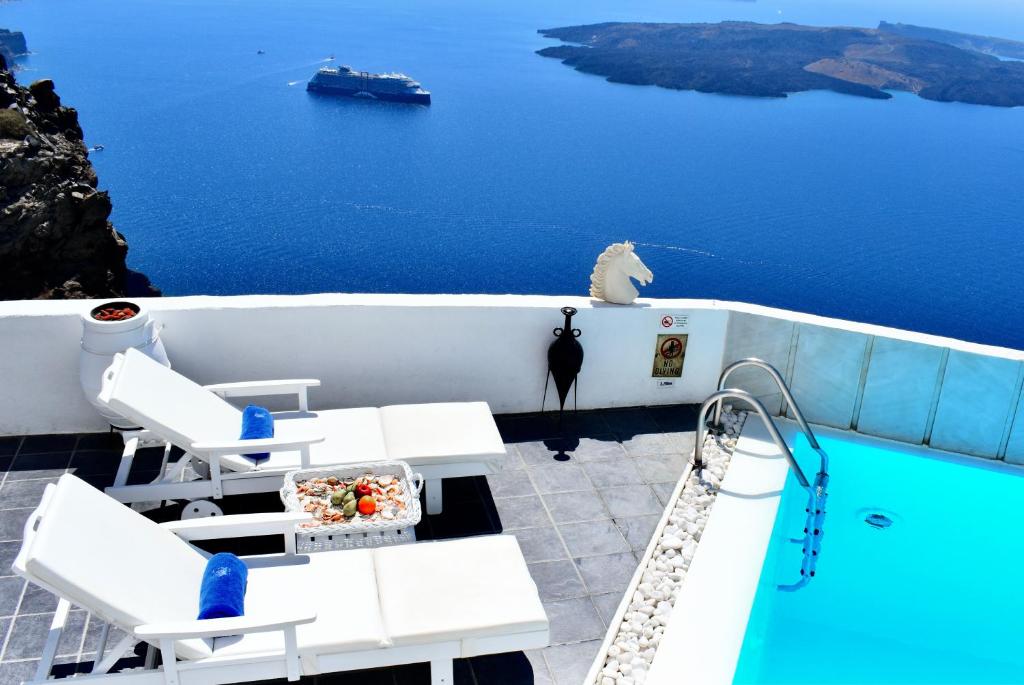 a view of a swimming pool and the ocean at Aeolos Art & Eco Suites Adults Only in Imerovigli
