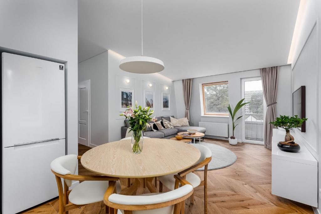 a kitchen and living room with a table and chairs at V33 cozy apartment in Druskininkai