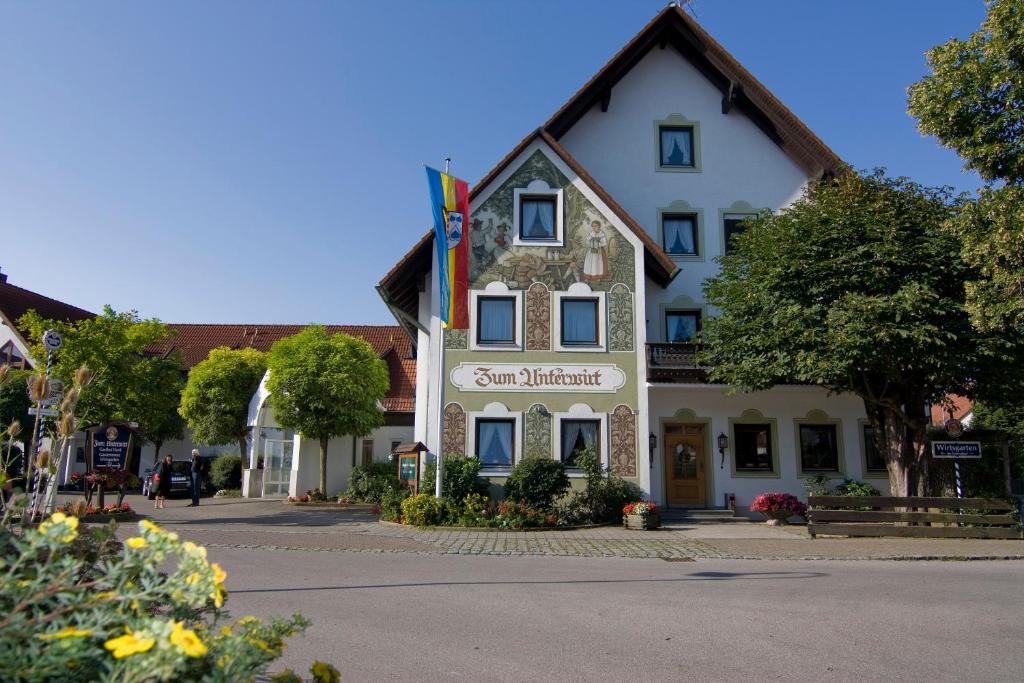 a large white building with a sign on it at Gasthof Hartl Zum Unterwirt in Türkenfeld
