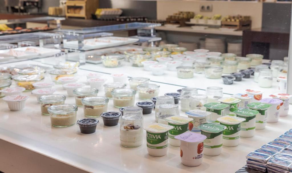 a table with many different types of food in jars at Ilunion Calas de Conil in Conil de la Frontera