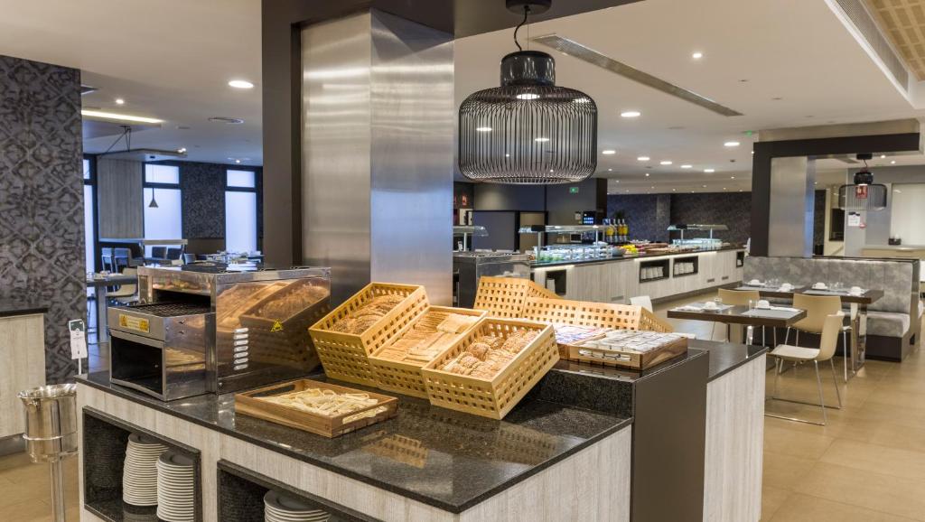 a kitchen with a counter with baskets on it at Ilunion Calas de Conil in Conil de la Frontera