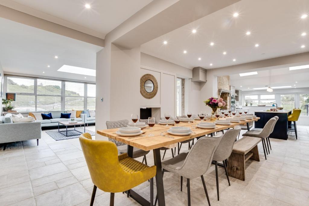 a large dining room with a long table and chairs at Castle View by Coast & Country Stays in Bamburgh