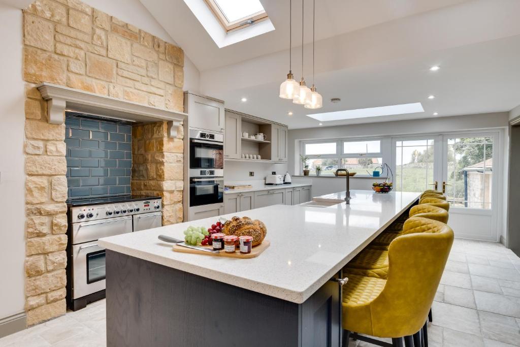 a kitchen with a large island with a counter top at Castle View in Bamburgh