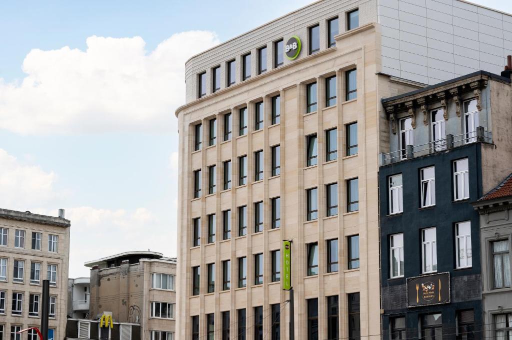 a tall building with many windows on a city street at B&B HOTEL Antwerpen Centrum in Antwerp