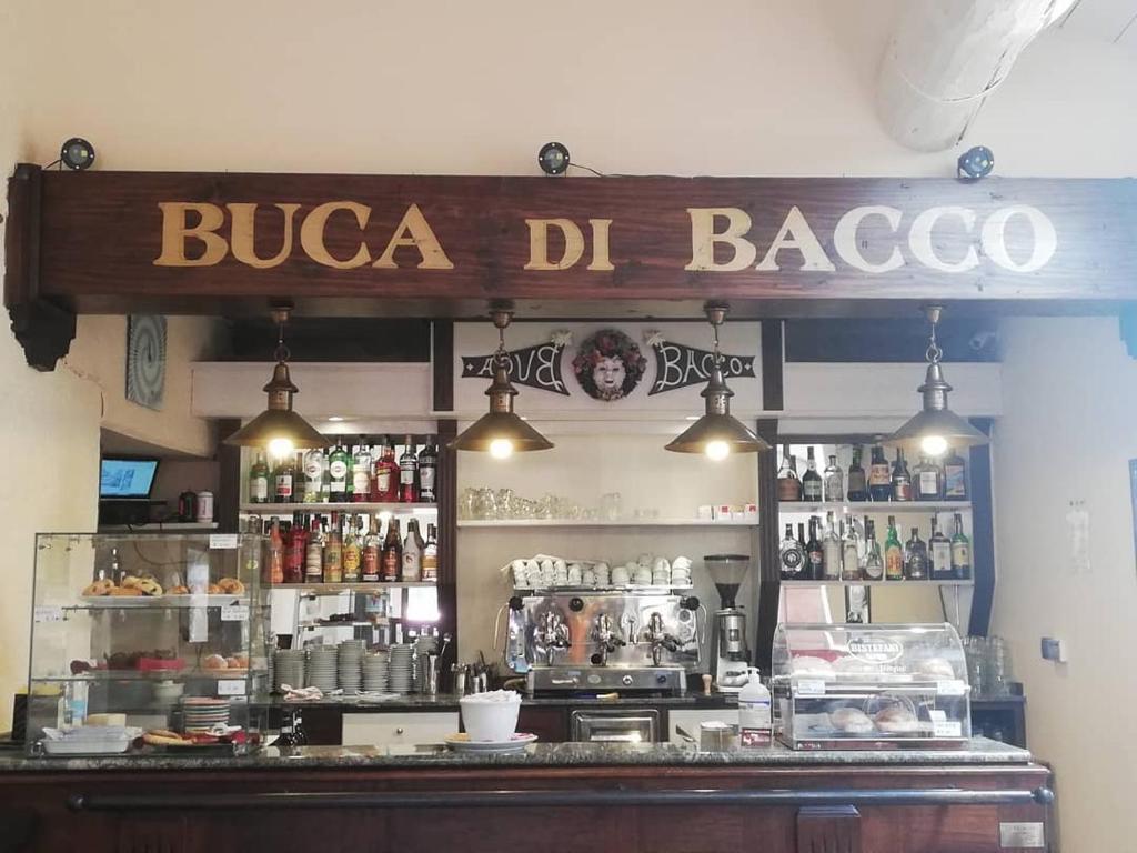 a bar with a sign that reads bucca del bago at Affittacamere Buca di Bacco in Pontechianale