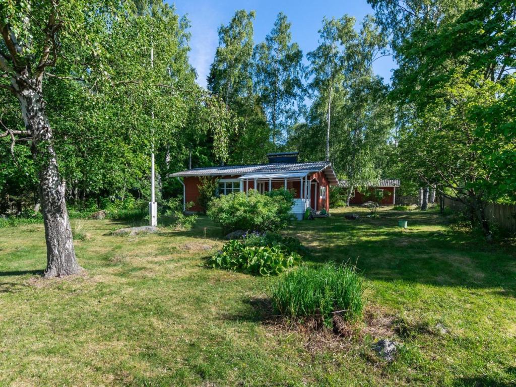 a small red cabin in the middle of a yard at Holiday Home Lampaluodon punainen tupa by Interhome in Tyltty