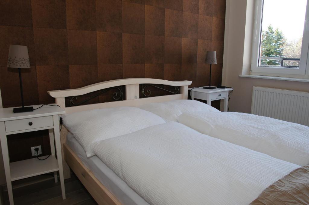 Posteľ alebo postele v izbe v ubytovaní Apartament Jedynka