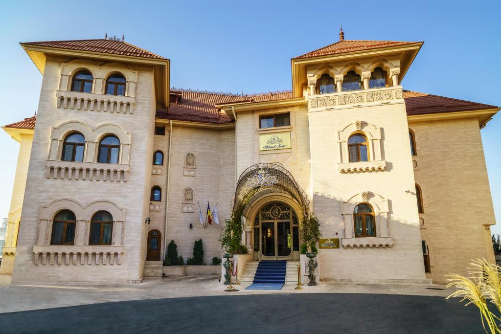 a large stone building with a large doorway at Suter Palace Heritage Boutique Hotel in Bucharest