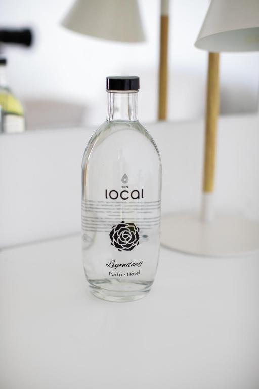 a bottle of vodka sitting on a table at Legendary Porto Hotel in Porto