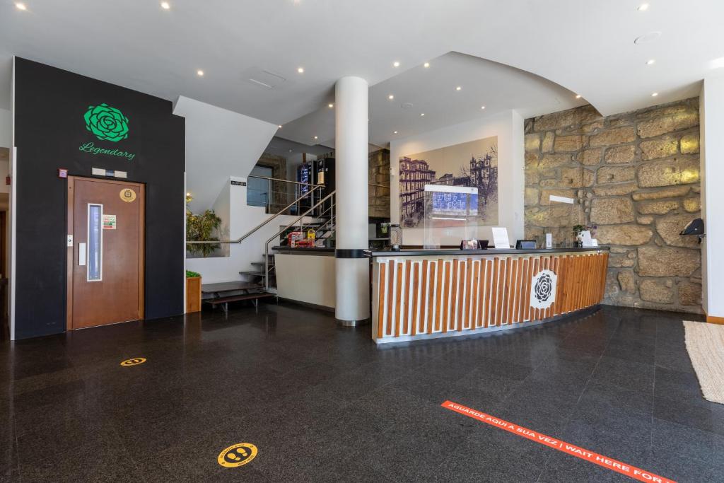 a restaurant with a counter in a building at Legendary Porto Hotel in Porto