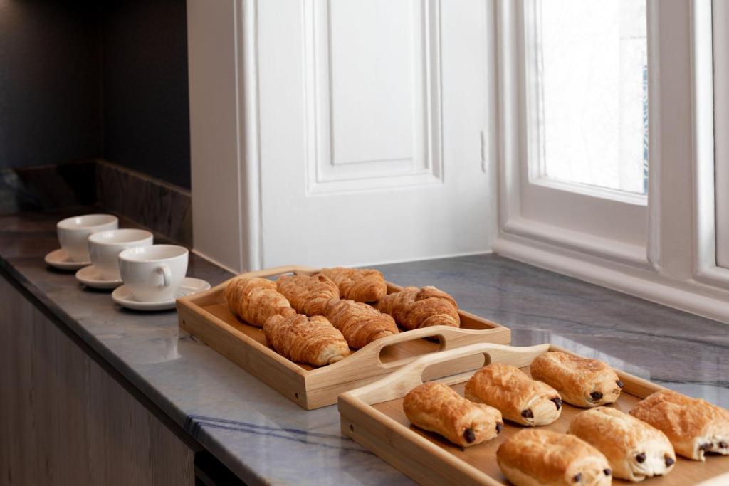 a table with two trays of pastries on it at Commodore Hotel in London