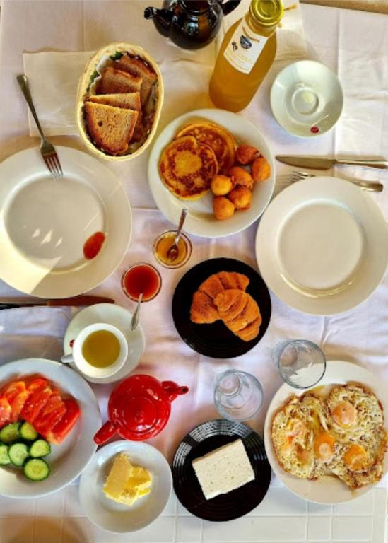 a table with many plates of food on it at Guesthouse Lord Byron in Tepelenë