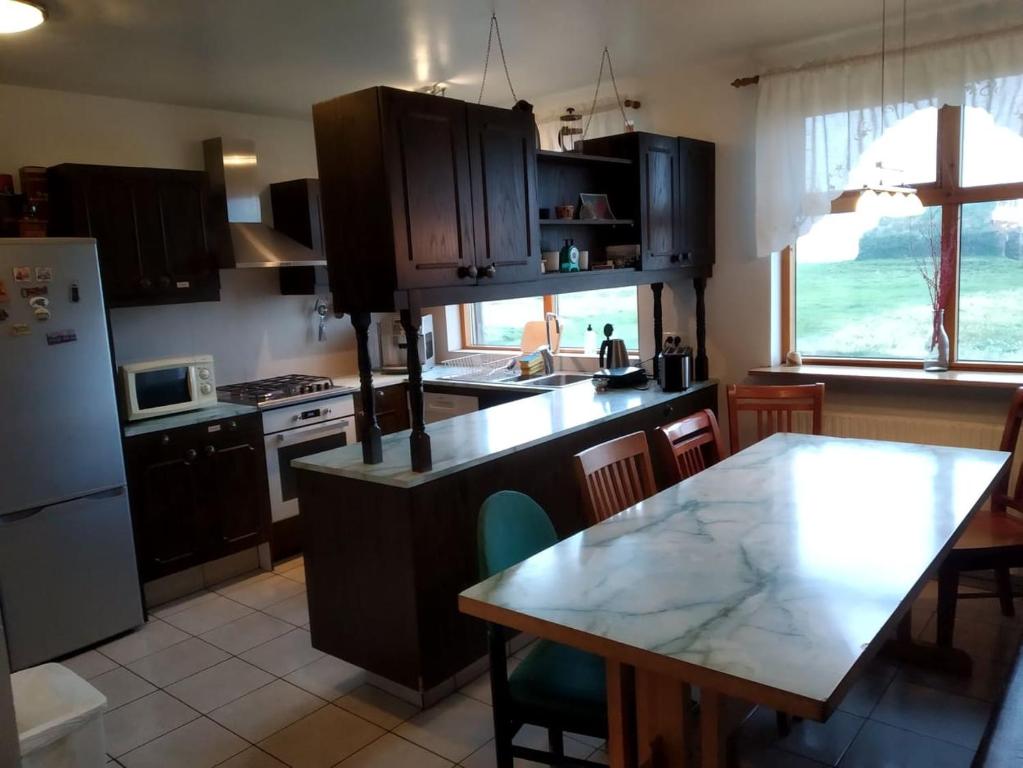 a kitchen with a table and a counter top at Fjalladýrð Guesthouse in Modrudalur