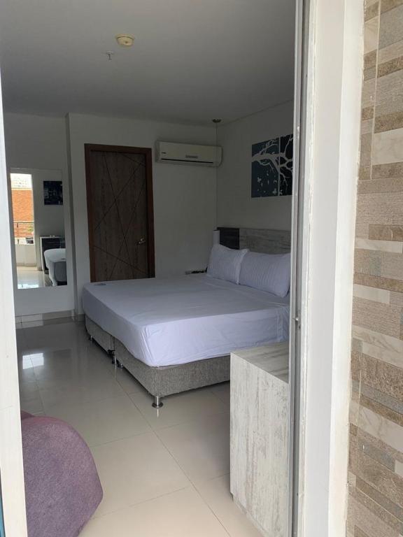 Postel nebo postele na pokoji v ubytování Hotel Oxford Barranquilla
