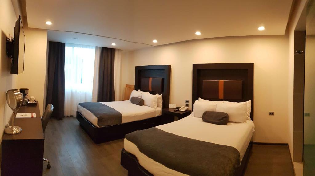 Una cama o camas en una habitación de Best Western Plus Metepec & Suites