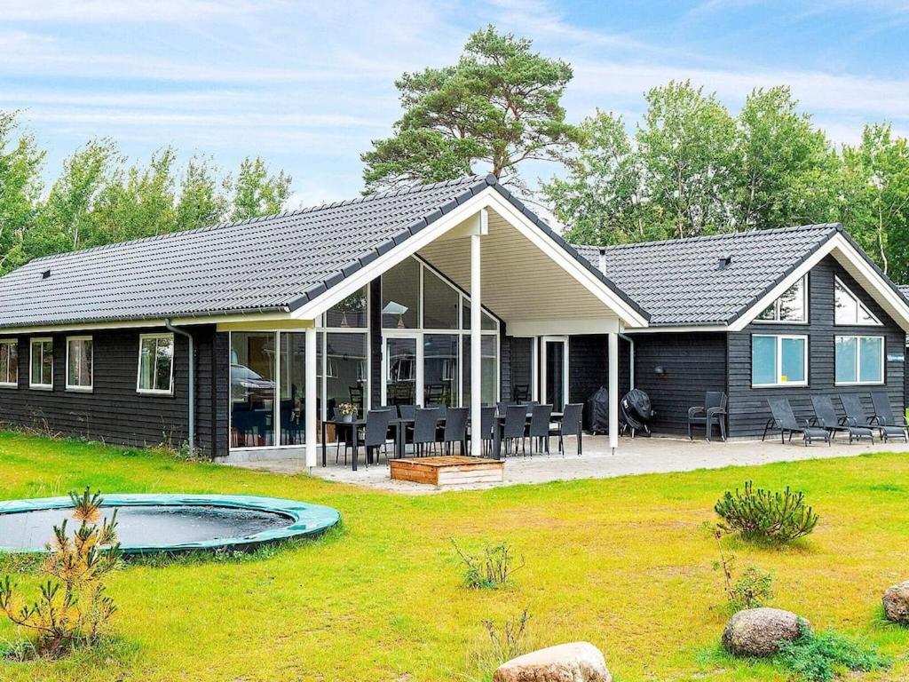 een huis met een zwembad in de tuin bij 18 person holiday home in V ggerl se in Bøtø By