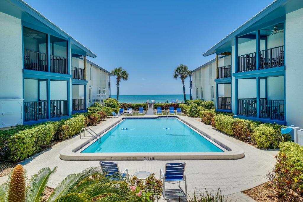 a swimming pool in the courtyard of a building at Sunset Connection - Gulf Place in Holmes Beach