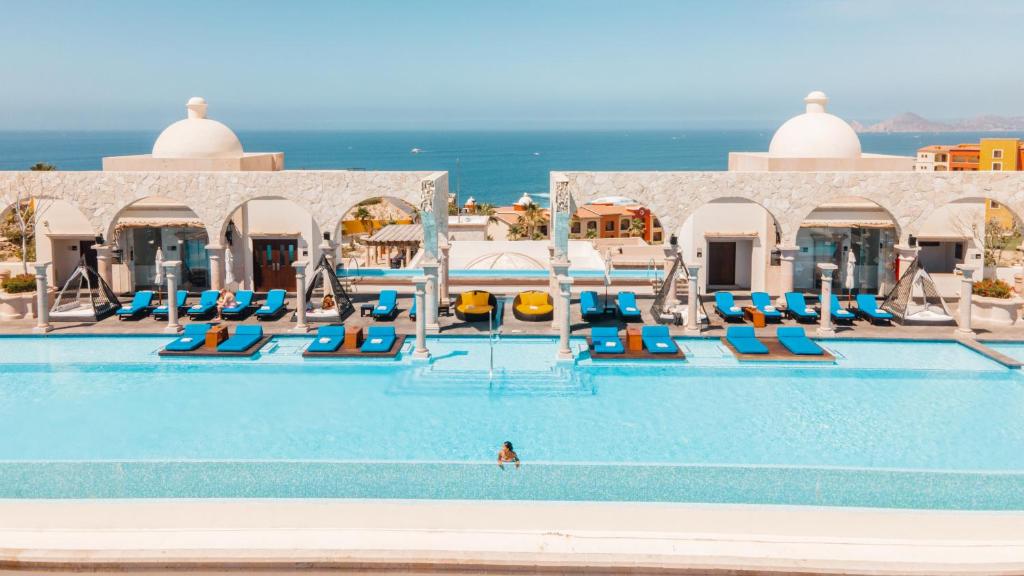 a pool at a resort with a person in the water at Vista Encantada Resort & Spa Residences, A La Carte All Inclusive Optional in Cabo San Lucas