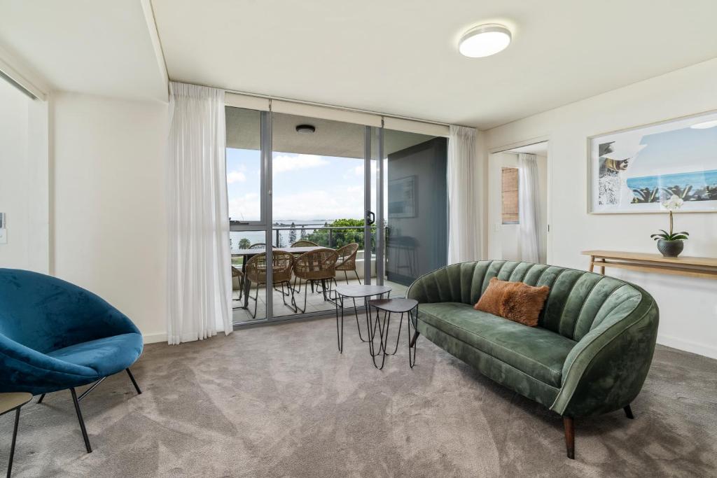 a living room with a couch and a table at Terminus Apartment Hotel Newcastle in Newcastle