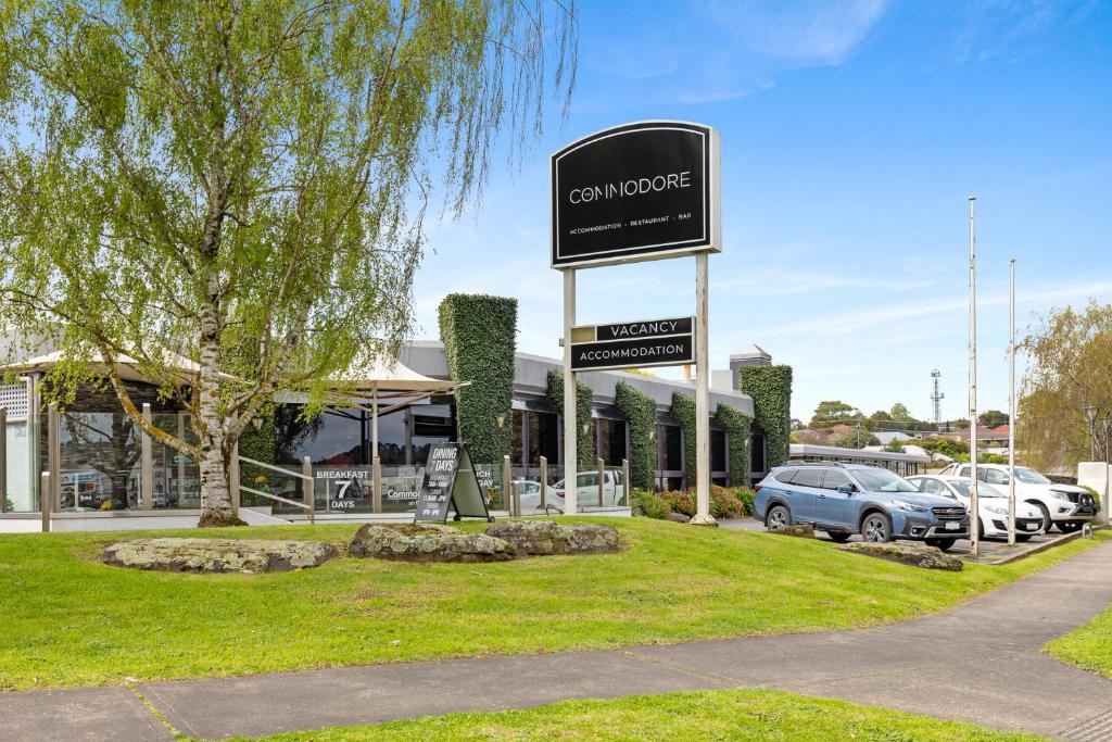 a sign for a car workshop in front of a building at The Commodore in Mount Gambier