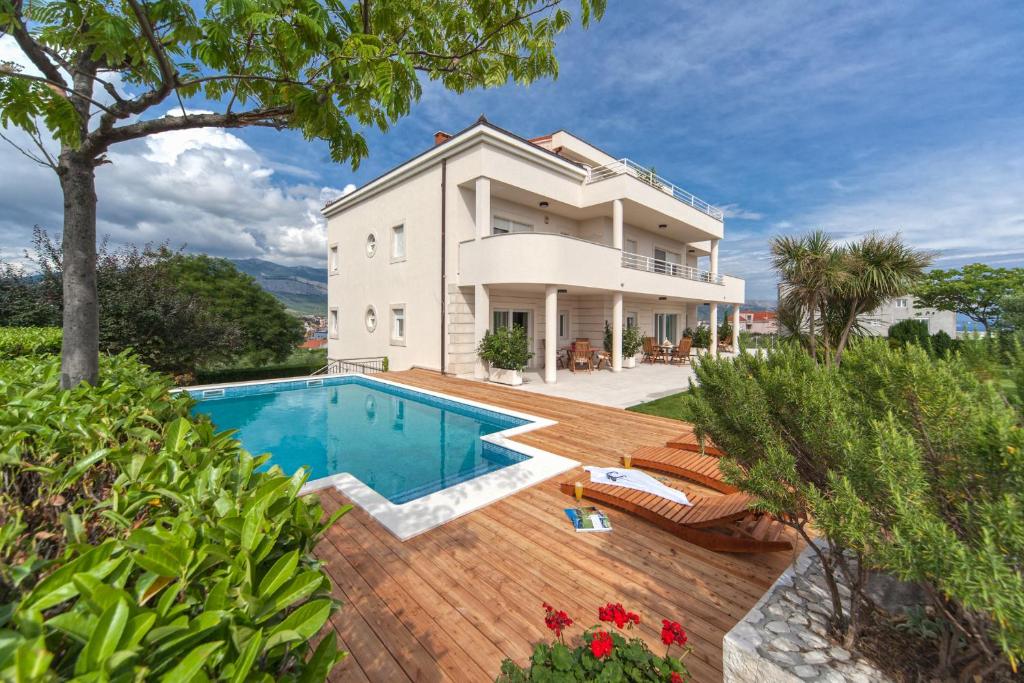 an exterior view of a house with a swimming pool at Luxury Apartments Klara in Split