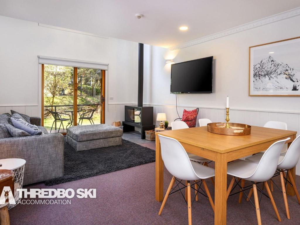 a living room with a table and a couch at Granite Peaks 4 in Thredbo